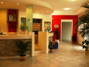 a lobby with potted plants in a building at Residence Hotel Matilde in Carpineti