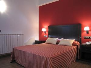 Säng eller sängar i ett rum på Hotel Sesué