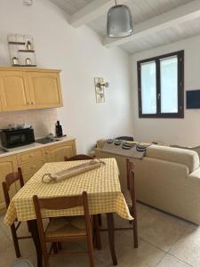 a kitchen with a table and a bed in a room at Agriturismo il maniero in Ancona