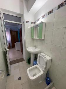 a bathroom with a toilet and a sink at Vila Frroku in Shëngjin +10 photos