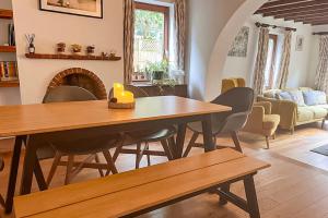 a living room with a wooden table and chairs at Gorgeous Family 3 Bedroom Home in Newbury