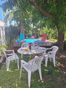 a white table and chairs under a tree at Nuestra Casa in San Pedro +12 photos