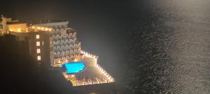 a cruise ship lit up at night next to the water at L'incanto Blu in Teulada