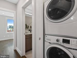 a kitchen with a washer and dryer in a house at Upscale 3BDR Penthouse with Rooftop TV and Stunning Capitol and Monument Views Near Popular H Street Corridor Parking Included Free Cancellation in Washington