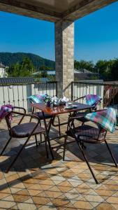a patio with a table and two chairs on a balcony at Cool Family House Gabala in Gabala +44 photos