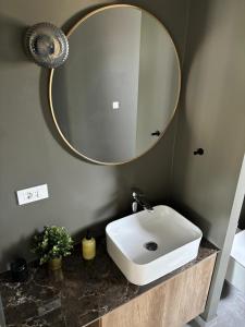 a bathroom with a sink and a mirror at Villa Panorama Rakitno in Posušje +13 photos