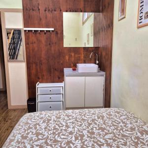 a bathroom with a bed and a sink in a room at Roi Guesthouse in Seoul