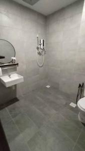 a bathroom with a shower and a sink and a toilet at Yumi Staycation 3R2B, Doncaster Residence in Maong Bazaar +12 photos