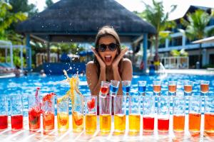 a woman in a pool with a bunch of glasses at Ocean's Creek Beach Hotel in Balaclava