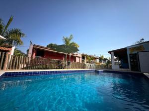 a swimming pool in front of a house at Recanto da Serra in Pardinho