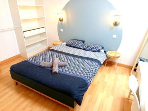 a bedroom with a bed with a stuffed animal on it at Escapade, T3 Proche gare in Cholet