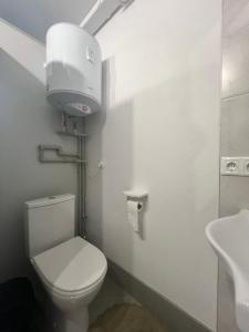 a bathroom with a white toilet and a sink at Хостел Житомир GREEN HOUSE in Zhytomyr +71 photos