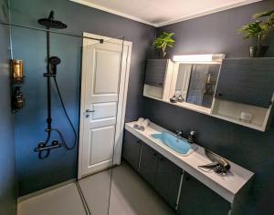 a bathroom with a sink and a mirror at Fjellhagen - Geirangerfjord view in Hellesylt +45 photos