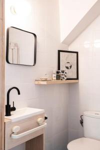 a white bathroom with a sink and a mirror at Suite Romantica en el campo, Cantallops, Girona in Cantallops +15 photos