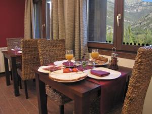 a dining room table with food and glasses of wine at Hotel Sesué in Sesué