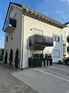 a white building with balconies on the side of it at Ferienwohnung Gergert Nr 5 in Löwenstein