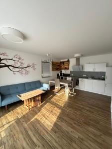a living room with a blue couch and a piano at Ferienwohnung Gergert Nr 5 in Löwenstein