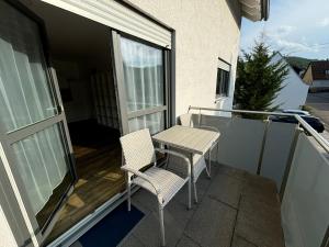 a patio with two chairs and a table on a balcony at Ferienwohnung Gergert Nr 5 in Löwenstein