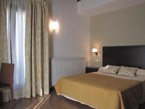 Voodi või voodid majutusasutuse Hotel Sesué toas