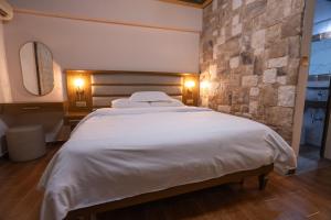 Postel nebo postele na pokoji v ubytování Kallinikos Guesthouse