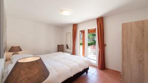 a bedroom with a white bed and a window at Villa Alize in Vallon-Pont-dʼArc +19 photos