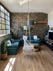 a living room with a hammock in the middle at La Verrière Berges du Tarn - Centre historique in Millau
