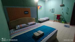 Postel nebo postele na pokoji v ubytování Perhentian Sealife Inn
