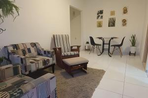 a living room with couches and chairs and a table at Vila Boulevard Aconchegante in Manaus