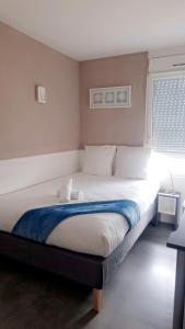 a large bed in a room with a window at Moov'Appart Hotel Clichy in Clichy
