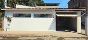 a white garage with a white garage door at Casa BNH in Cachoeiro de Itapemirim