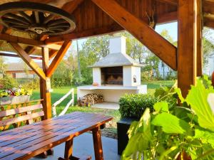 a wood fired grill in a garden with a wooden bench at Annie's apartment in Rakovica