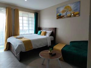 内罗毕Twende stays的一间卧室，里面有一张床、一张沙发和一张桌子