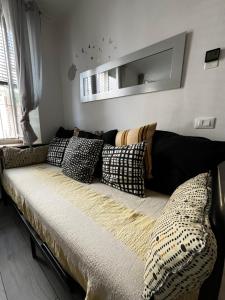 a bed with pillows on it in a room at Intellihost - Casa Giulietta Lonato del Garda in Lonato +22 photos