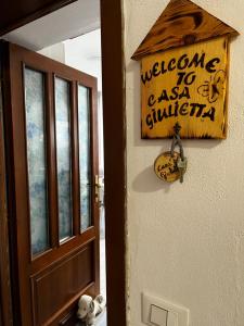 a door with a sign that says welcome to asian civilization at Intellihost - Casa Giulietta Lonato del Garda in Lonato