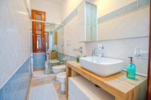 un baño con lavabo e inodoro en Perseo case vacanze Mameli Apartment, en Olbia