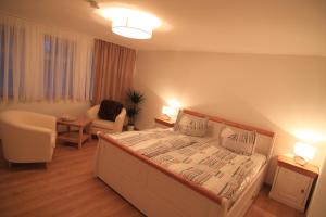 a bedroom with a bed and a couch and a chair at City Apartments in Erfurt