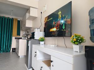 a living room with a tv on the wall at Twende stays in Nairobi