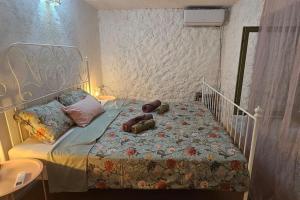 a bedroom with a bed with two teddy bears on it at Stone Three bedroom house with rooftop terrace in Jezera