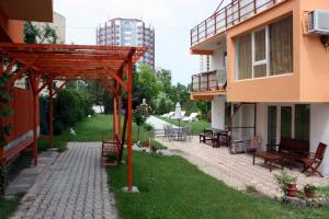 a patio in the middle of a building with benches at Vila Bucura 19 A in Venus +11 photos