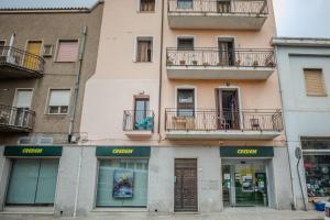 Un edificio alto con ventanas y balcones. en Perseo case vacanze Mameli Apartment, en Olbia