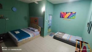 Postel nebo postele na pokoji v ubytování Perhentian Sealife Inn