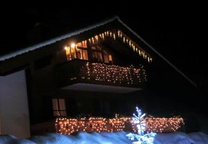 a building with christmas lights on it at night at Ferienwohnungen Haid in Schönau am Königssee