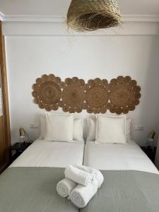 a bedroom with a bed with two towels on it at Sea City Torremolinos Beach in Torremolinos