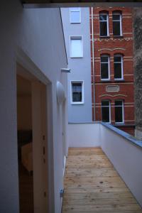 a hallway with a wooden floor and a building at City Apartments in Erfurt