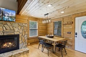 a dining room with a fireplace and a table and chairs at Ridgeview in Blowing Rock