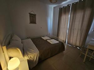 a bedroom with a bed and a clock on the wall at Villa Mare in Kiotari