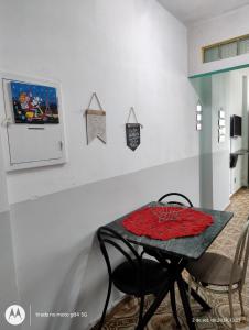 a table with two chairs and a table with a red pillow on it at Apartamento de frente a Praia, pé na areia com wi-fi LOFTJM com 01 vaga de garagem sujeita a disponibilidade in Santos