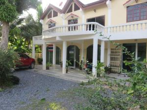 a house with a car parked in front of it at Private well priced Guesthouse available to rent in Koh Phangan