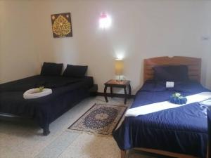 a living room with two beds and a couch at Private well priced Guesthouse available to rent in Koh Phangan