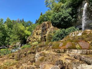 a waterfall on the side of a rocky mountain at Logement cosy et jardin in Saint-Laurent-en-Royans